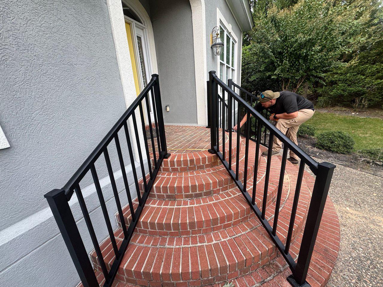 ornamental metal railing installed by top rail fence