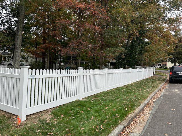 vinyl picket fence installed by top rail fence