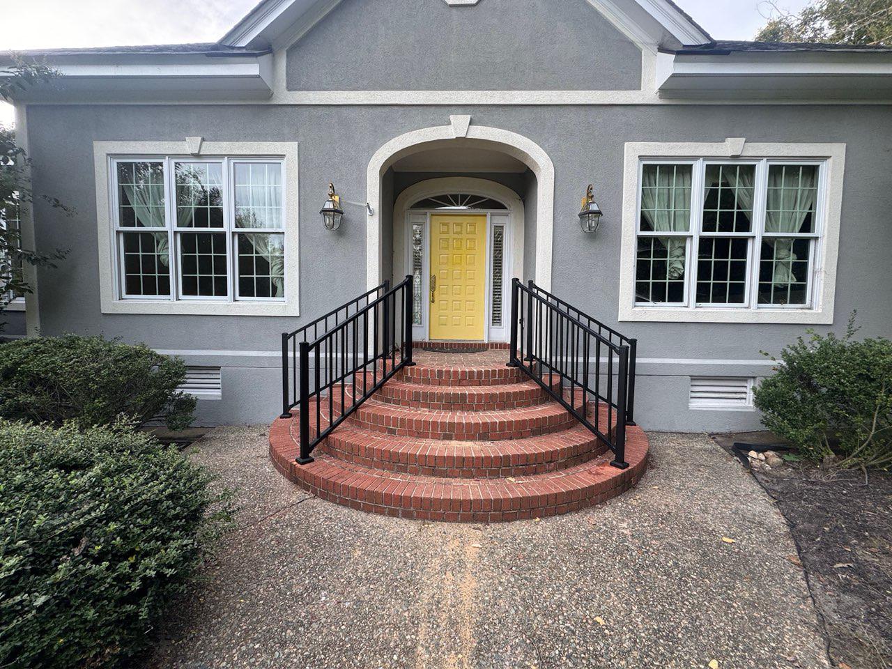 ornamental metal railing installed by top rail fence