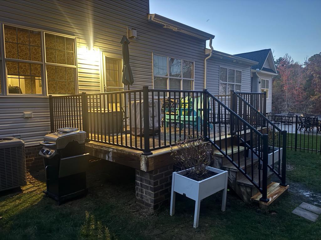 ornamental metal railing installed by top rail fence