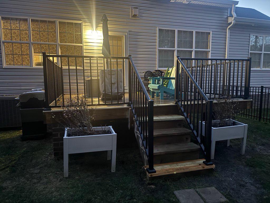 ornamental metal railing installed by top rail fence