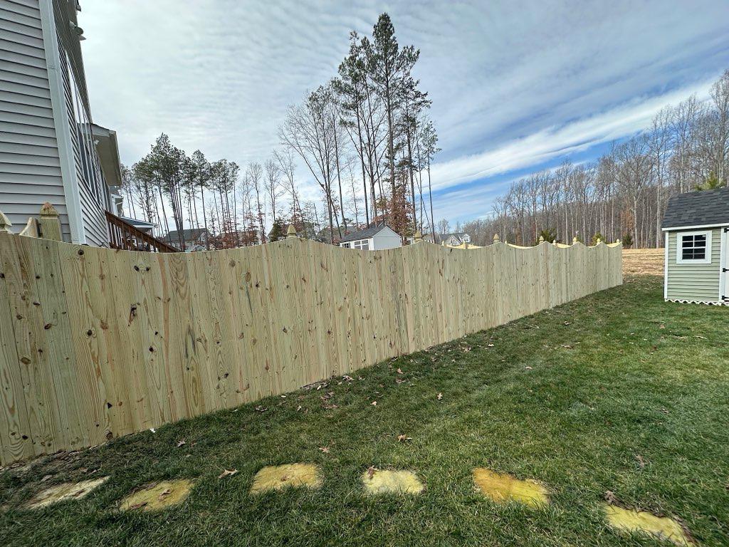wood stockade fence installed by top rail fence