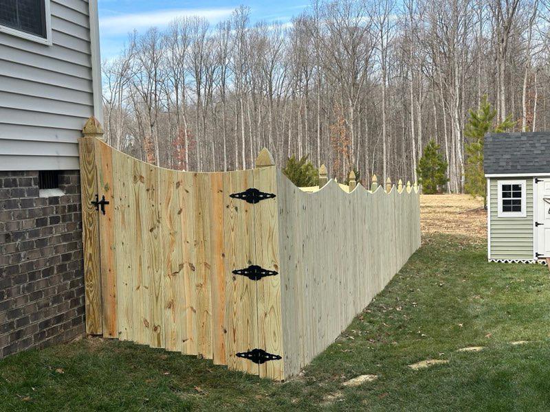wood stockade gate installed by top rail fence