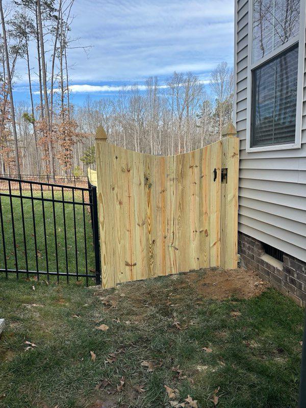 wood stockade gate installed by top rail fence