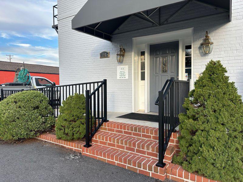 ornamental metal railing installed by top rail fence