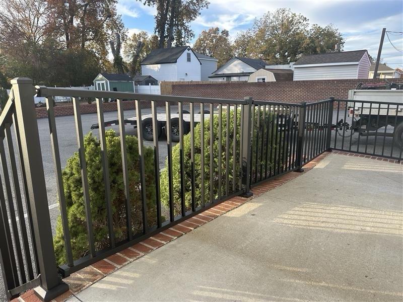 ornamental metal railing installed by top rail fence