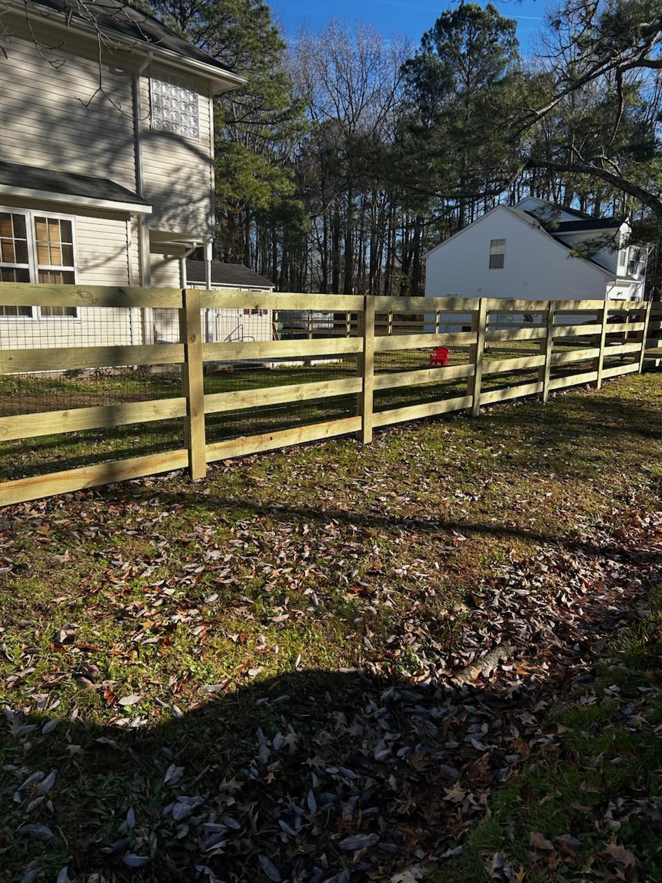 wood ranch rail installed by top rail fence