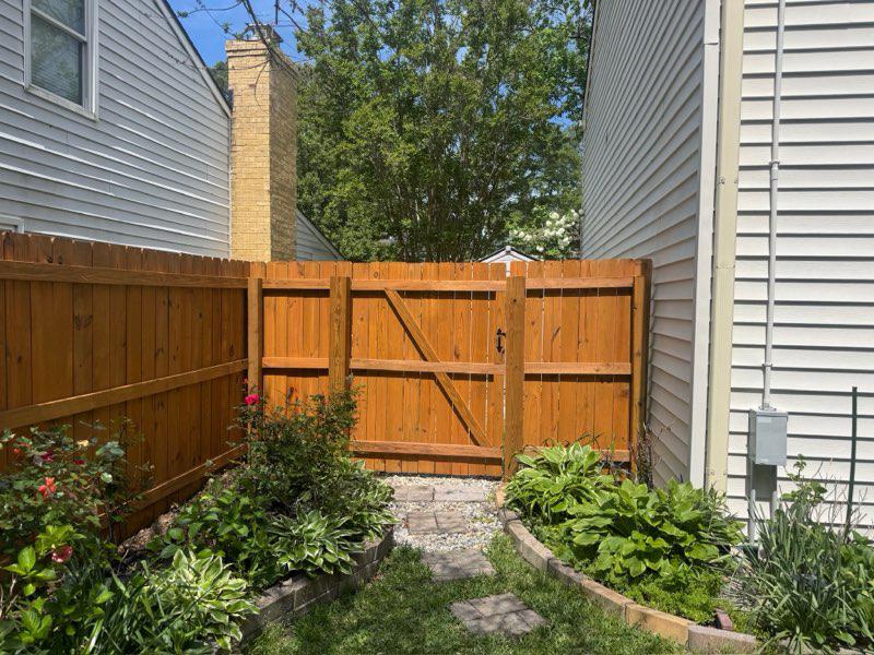 wood stockade fence installed by top rail fence