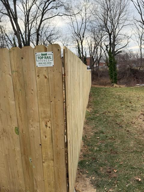 wood stockade fence installed by top rail fence