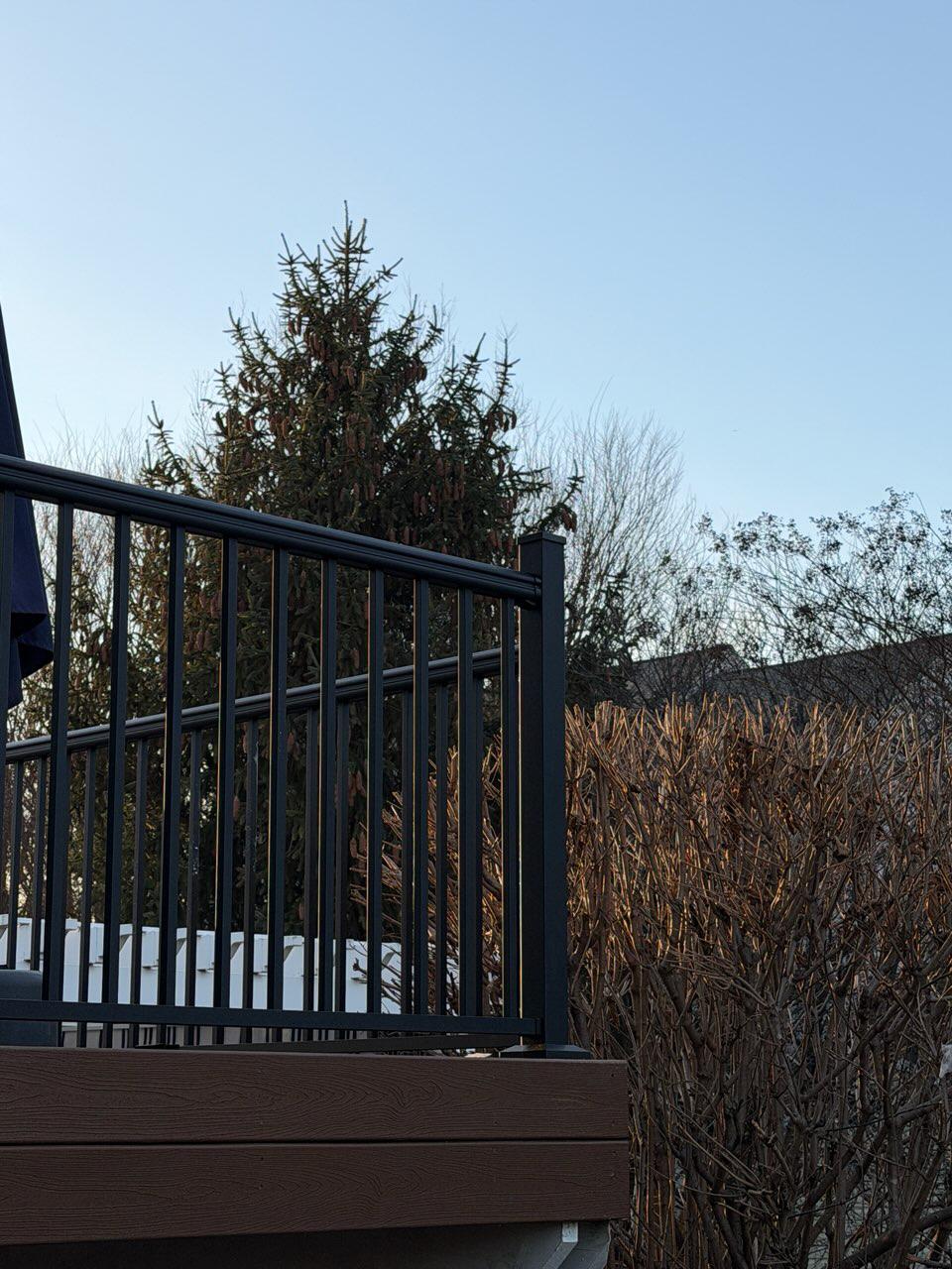 ornamental metal fence installed by top rail fence