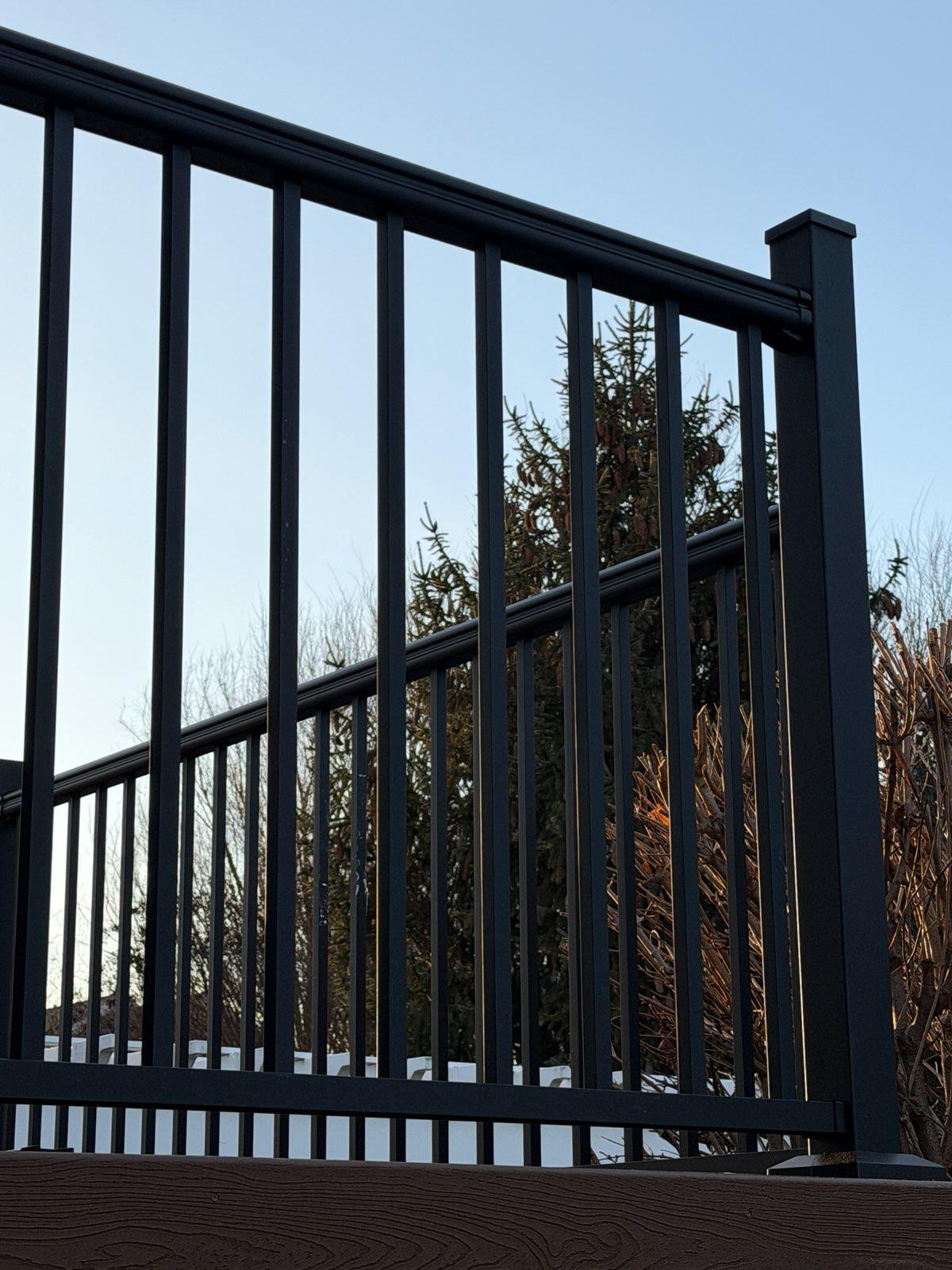 ornamental metal fence installed by top rail fence