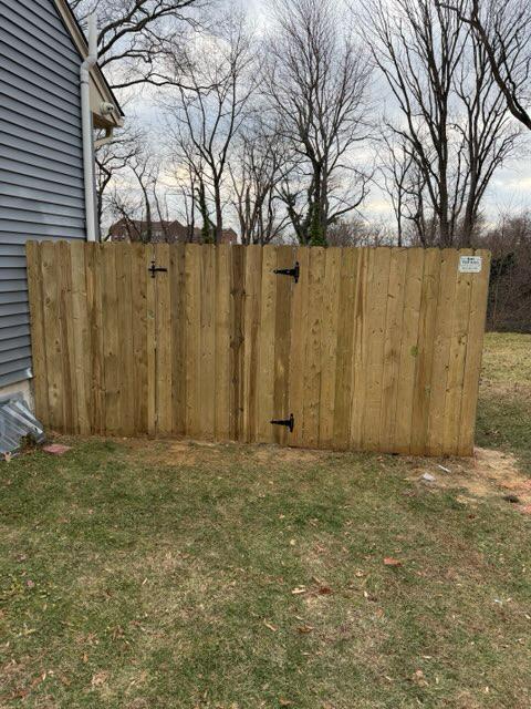 wood stockade fence installed by top rail fence