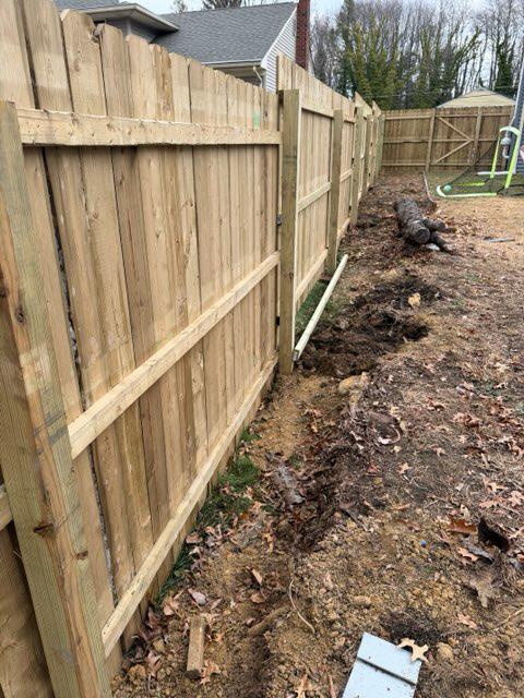 wood stockade fence installed by top rail fence