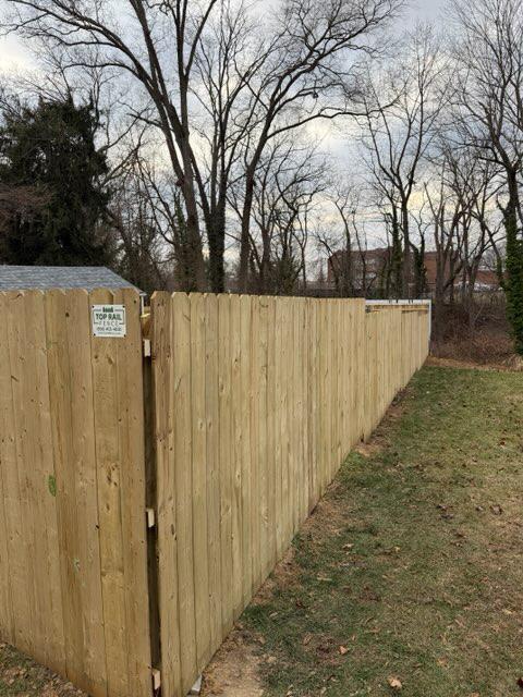 wood stockade fence installed by top rail fence