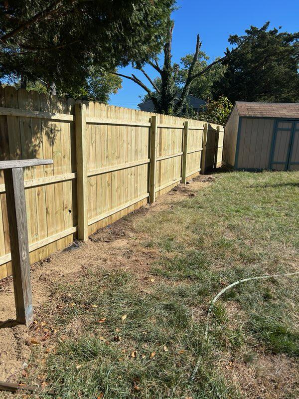 wood stockade fence installed by top rail fence