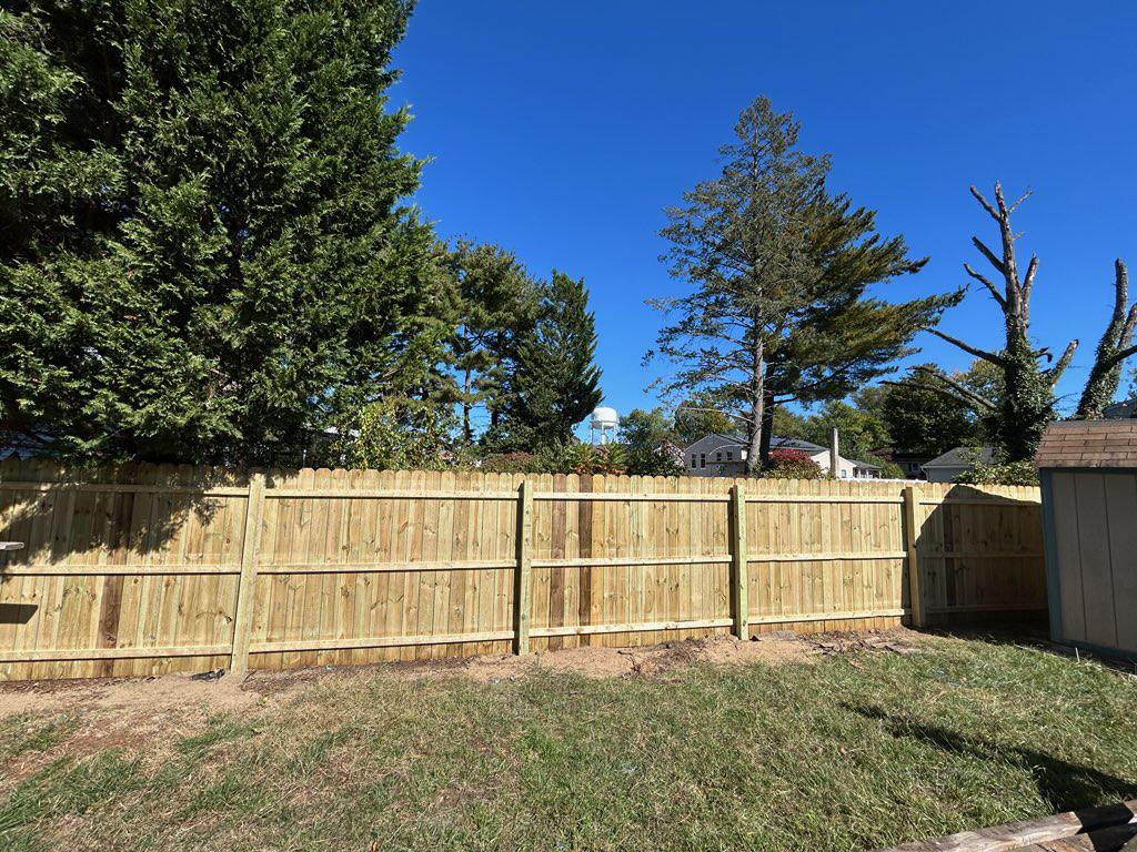wood stockade fence installed by top rail fence