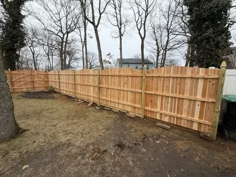 wood stockade fence installed by top rail fence