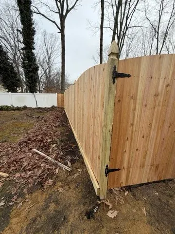 wood stockade fence installed by top rail fence