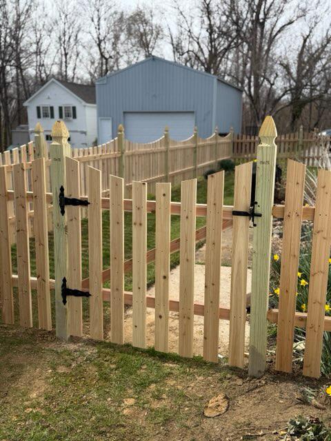 wood picket fence installed by top rail fence
