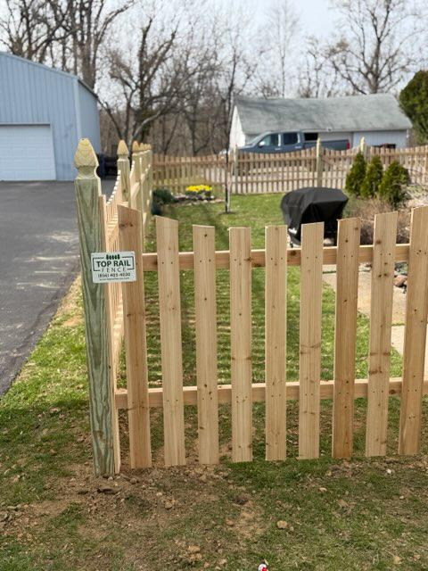 wood picket fence installed by top rail fence