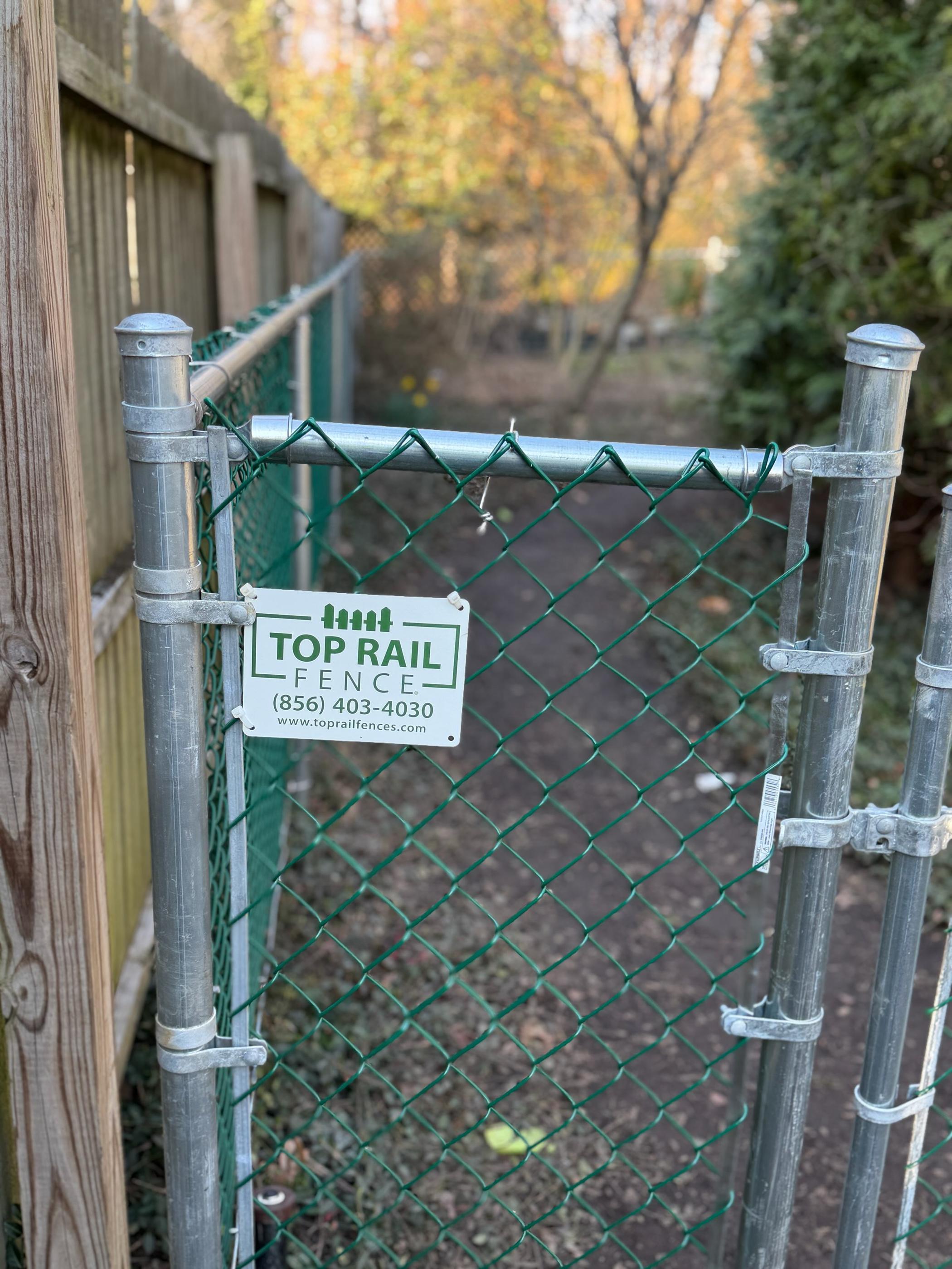 chain link fence installed by top rail fence