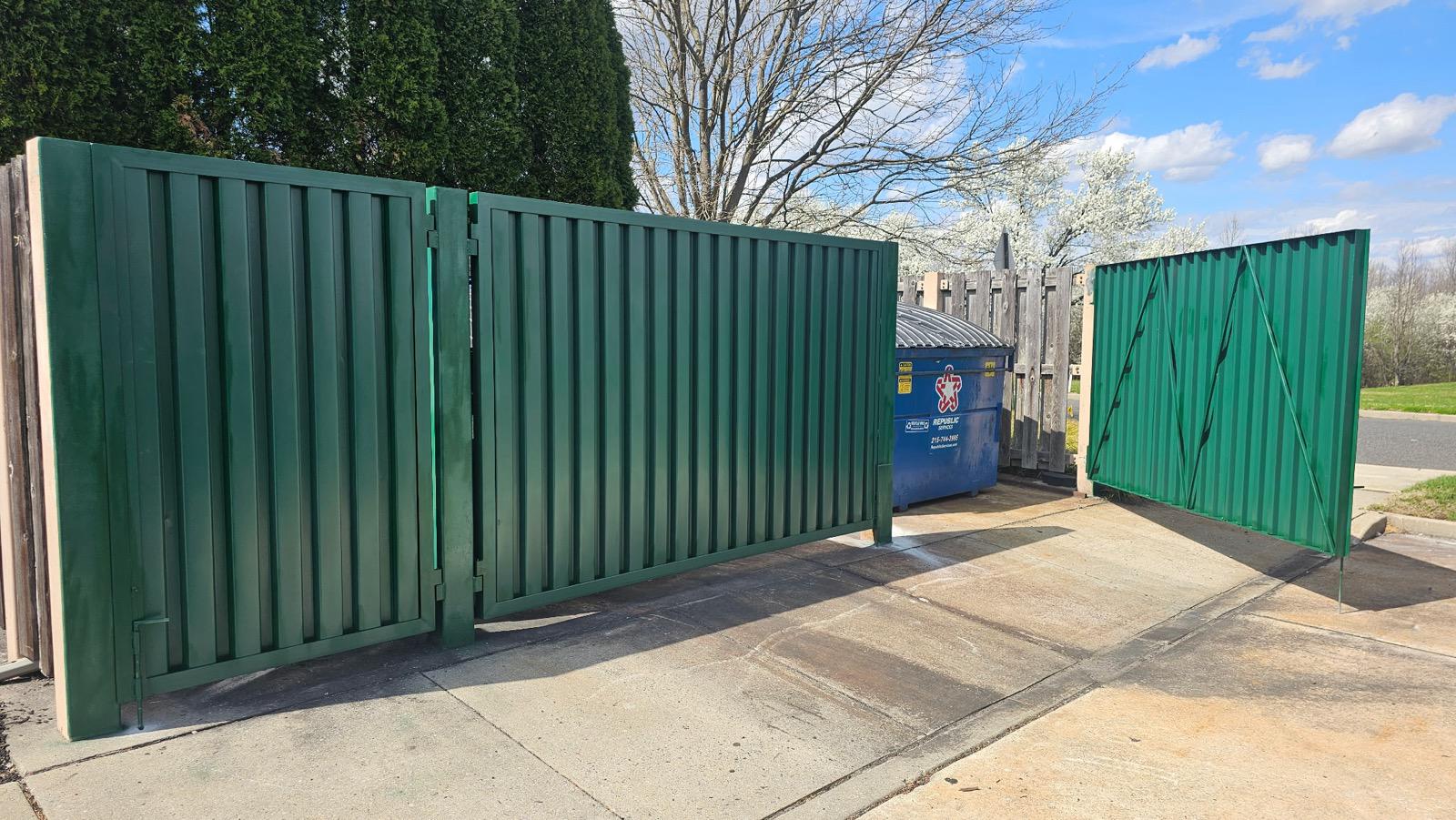 dumpster enclosure installed by top rail fence