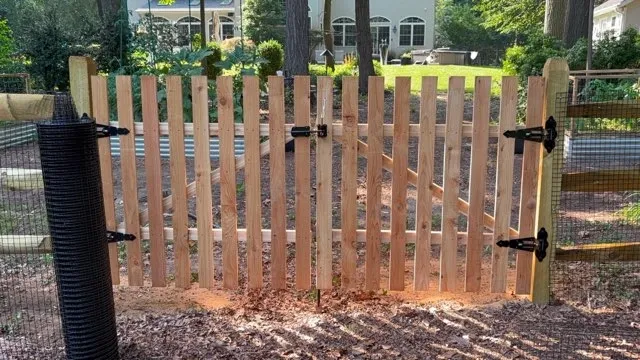 double wood picket gate installed by top rail fence
