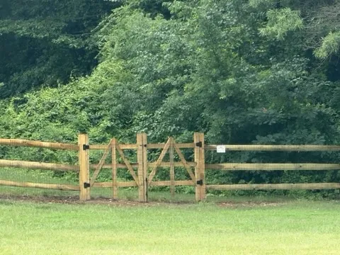 wood ranch rail fence installed by top rail fence