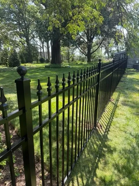 ornamental metal picket gate installed by top rail fence