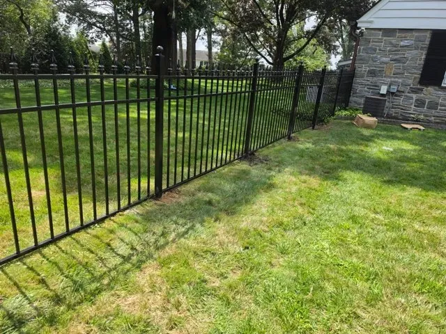 ornamental metal picket gate installed by top rail fence