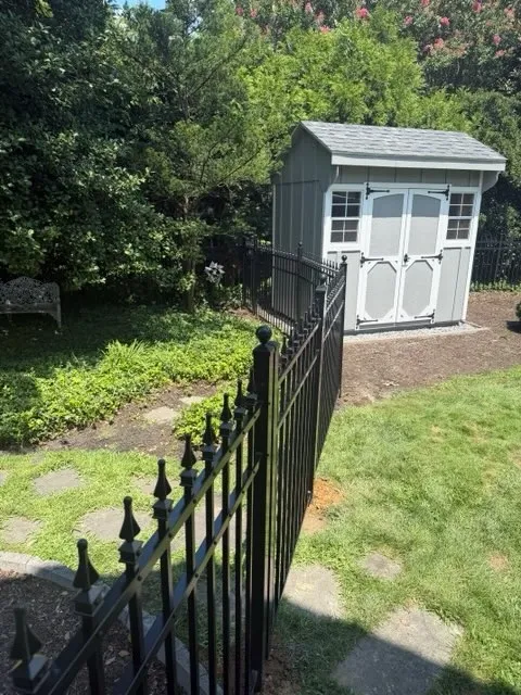 ornamental metal picket gate installed by top rail fence