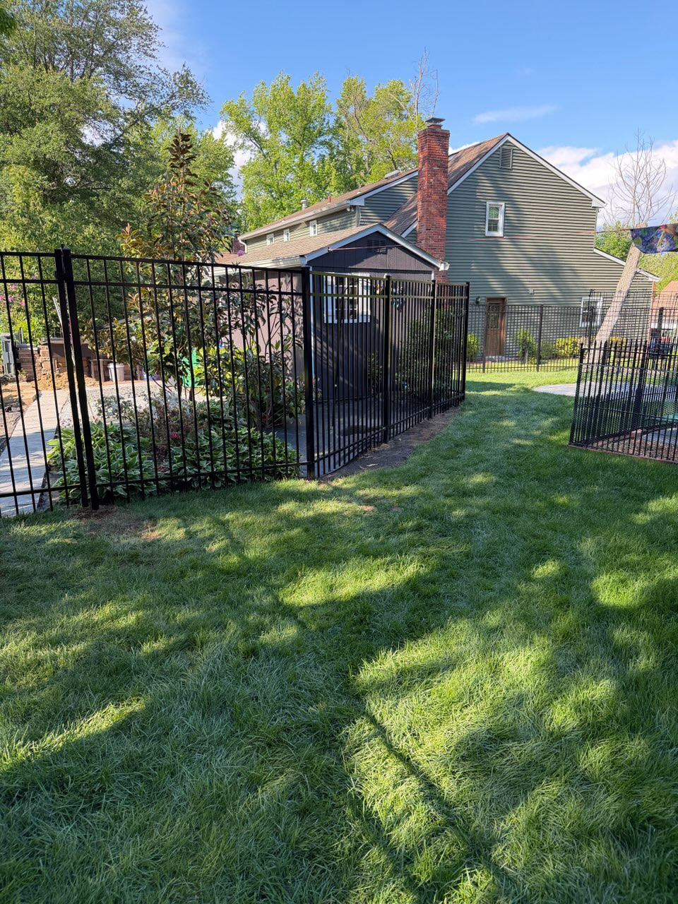 three rail ornamental metal fence installed by top rail fence