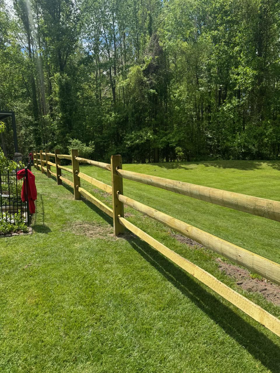 wood ranch rail fence installed by top rail fence