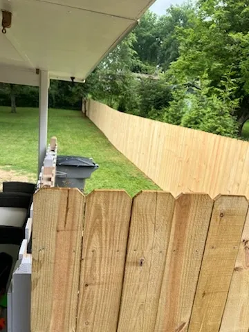 wood stockade fence installed by top rail fence