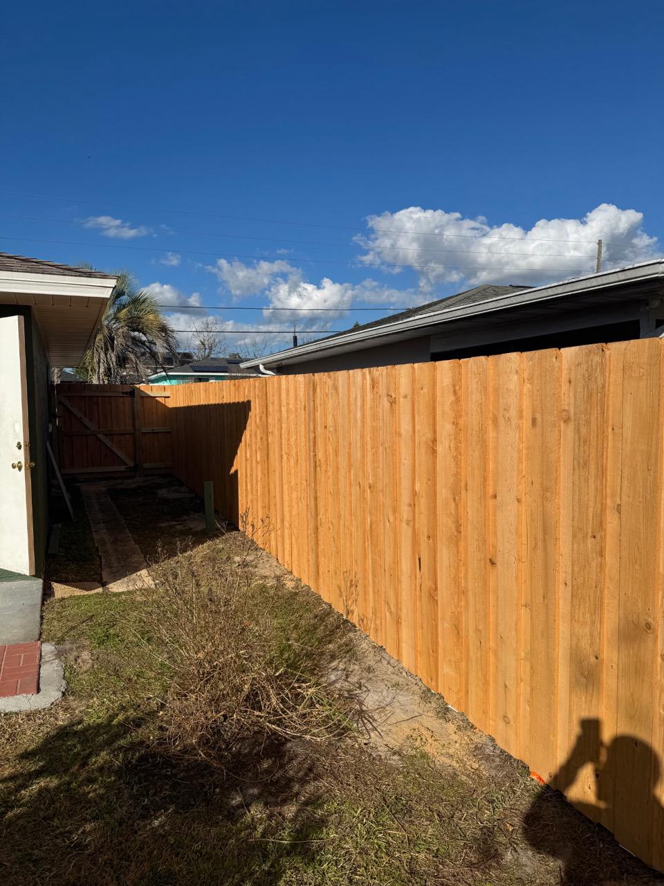 wood stockade fence installed by top rail fence