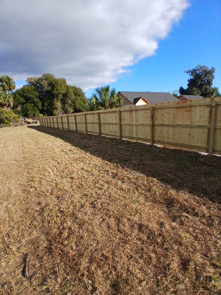 wood stockade fence installed by top rail fence