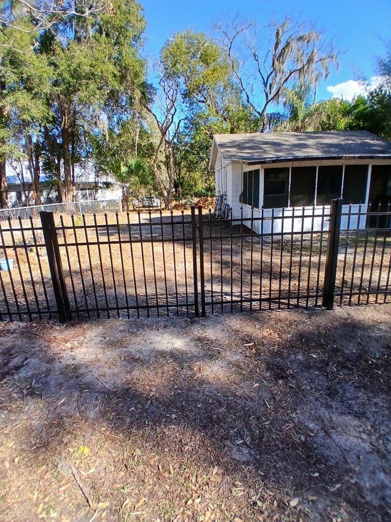 ornamental metal fence installed by top rail fence