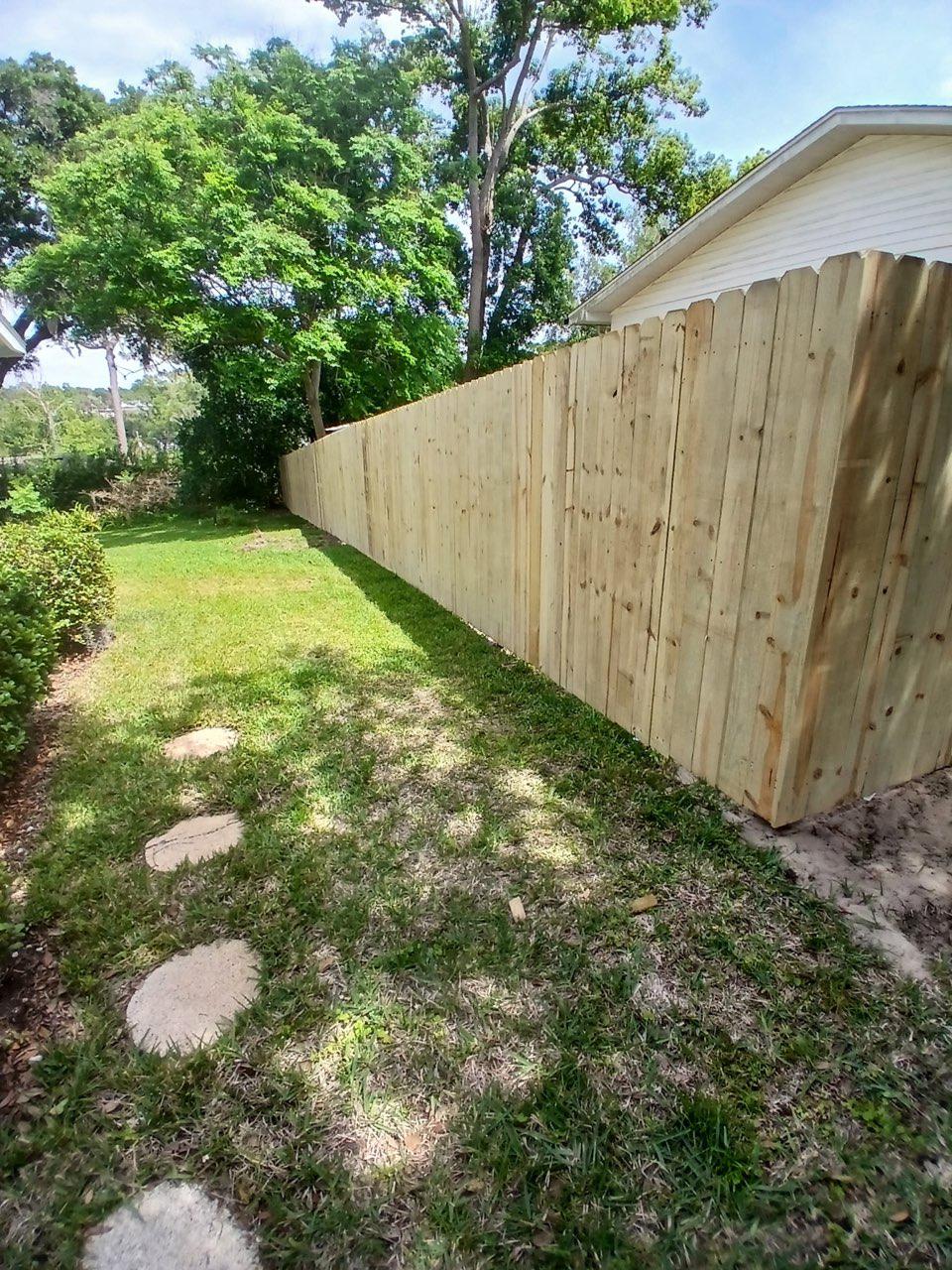 wood stockade fence installed by top rail fence