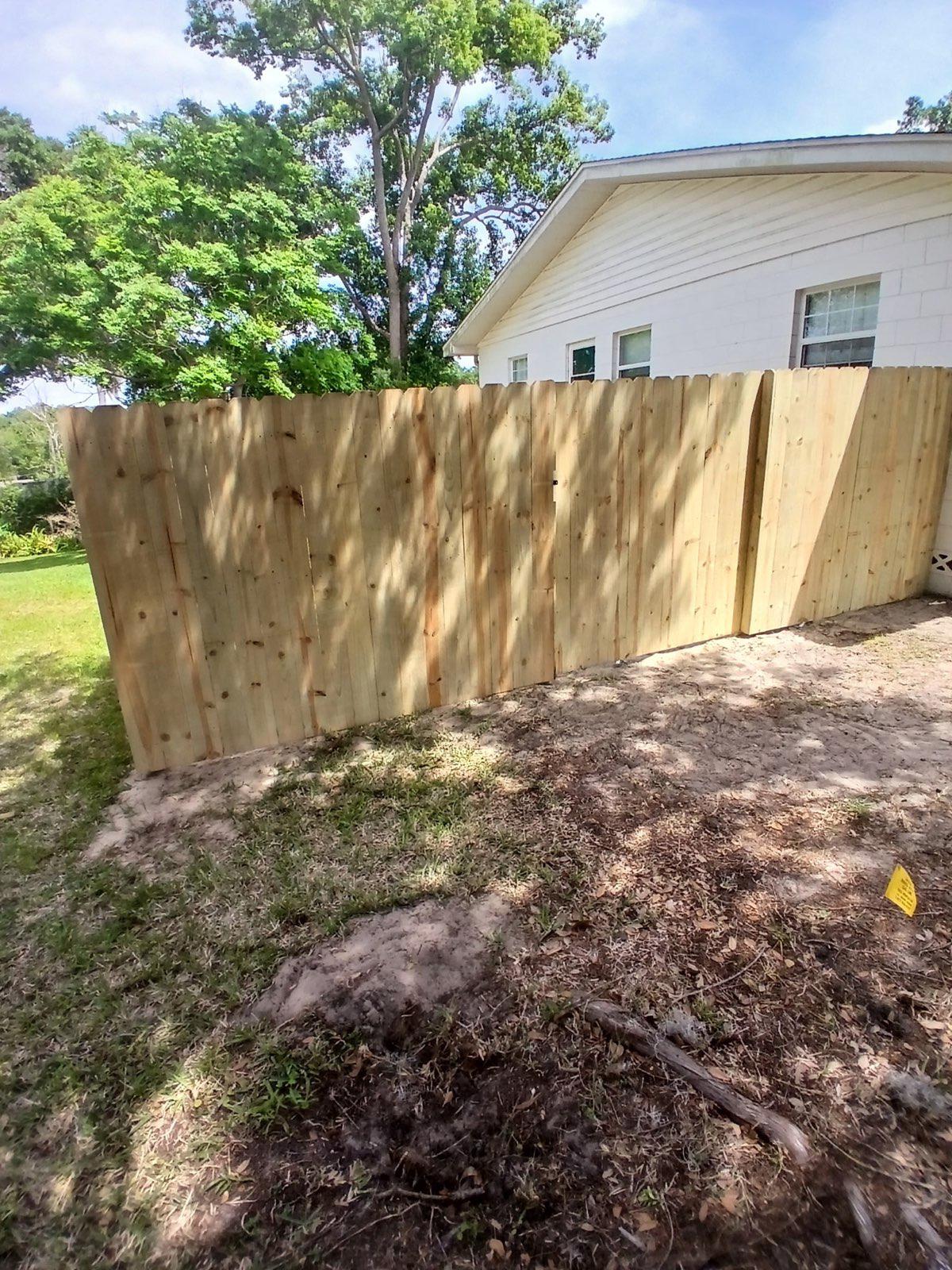 wood stockade fence installed by top rail fence