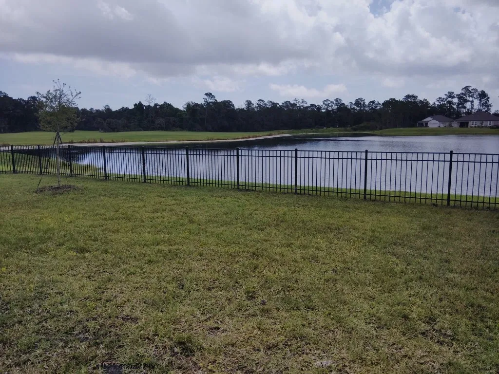 three rail ornamental metal fence installed by top rail fence