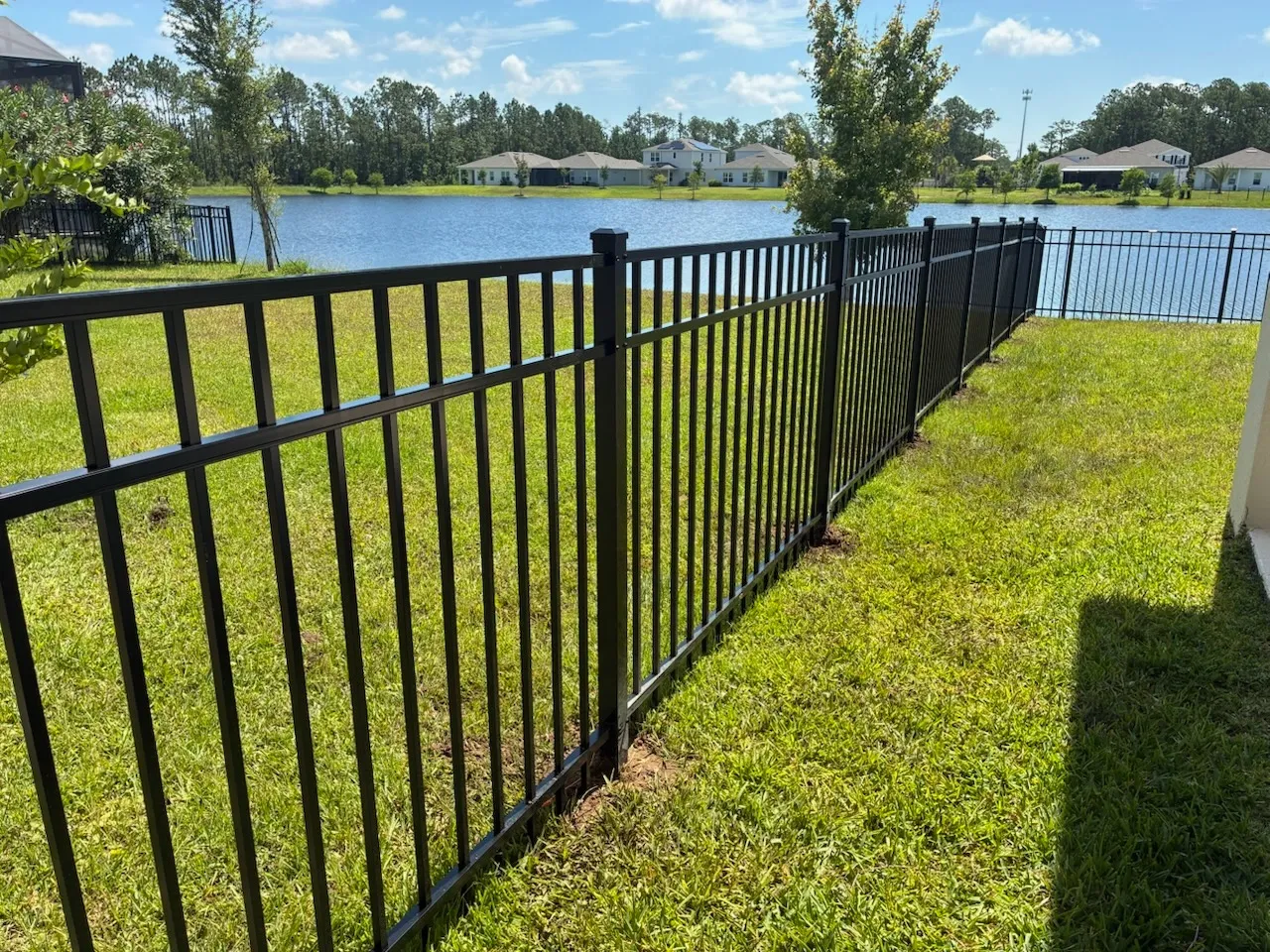 three rail ornamental metal fence installed by top rail fence