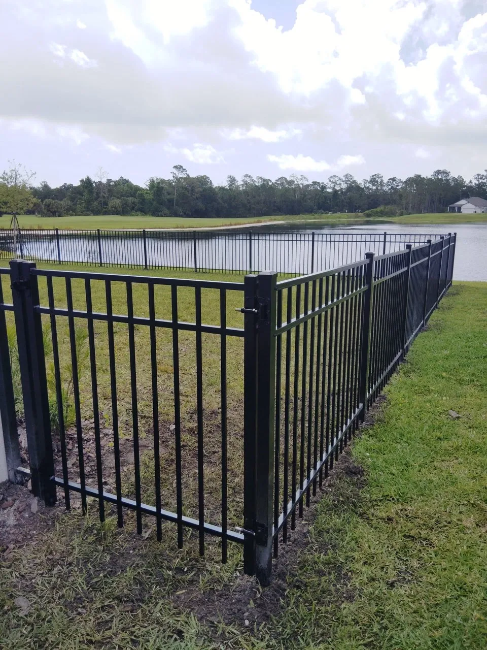 three rail ornamental metal fence installed by top rail fence