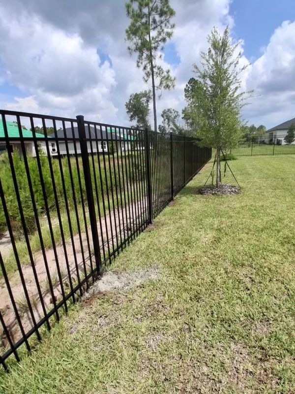 three rail ornamental metal fence installed by top rail fence