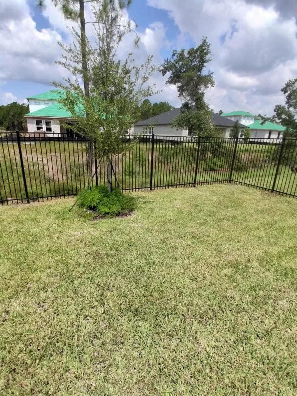 three rail ornamental metal fence installed by top rail fence