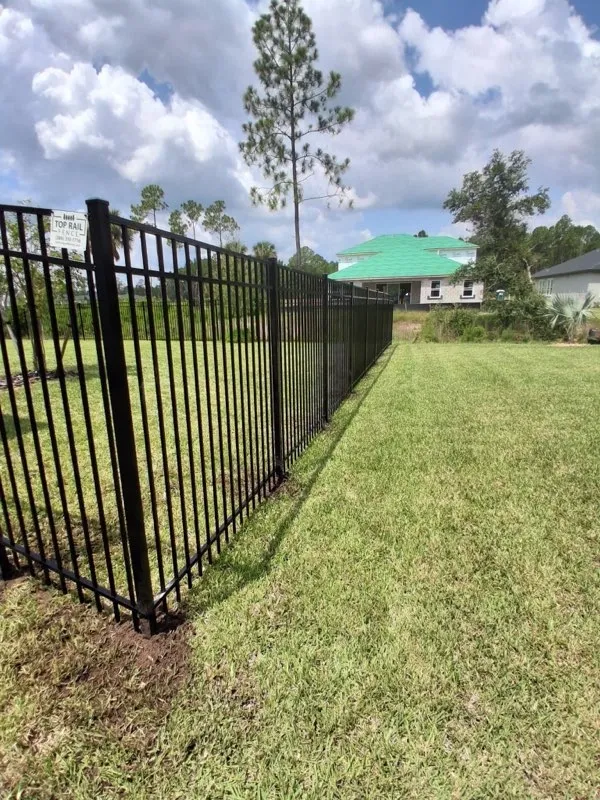 three rail ornamental metal fence installed by top rail fence