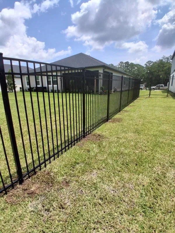 three rail ornamental metal fence installed by top rail fence