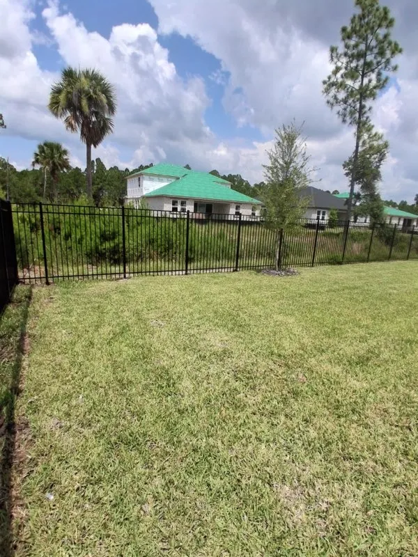 three rail ornamental metal fence installed by top rail fence