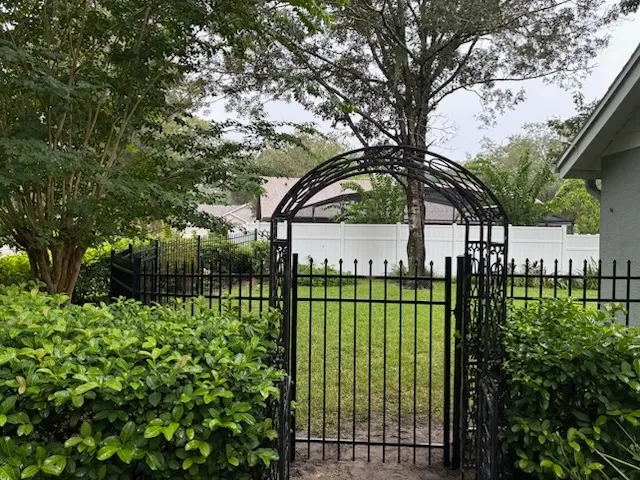 three rail ornamental metal fence installed by top rail fence