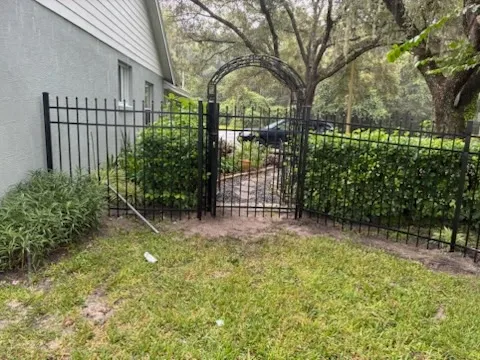 three rail ornamental metal fence installed by top rail fence