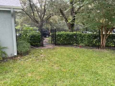 three rail ornamental metal fence installed by top rail fence